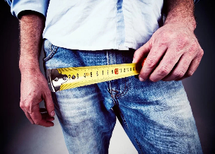 The man measured his penis with a tape measure. 